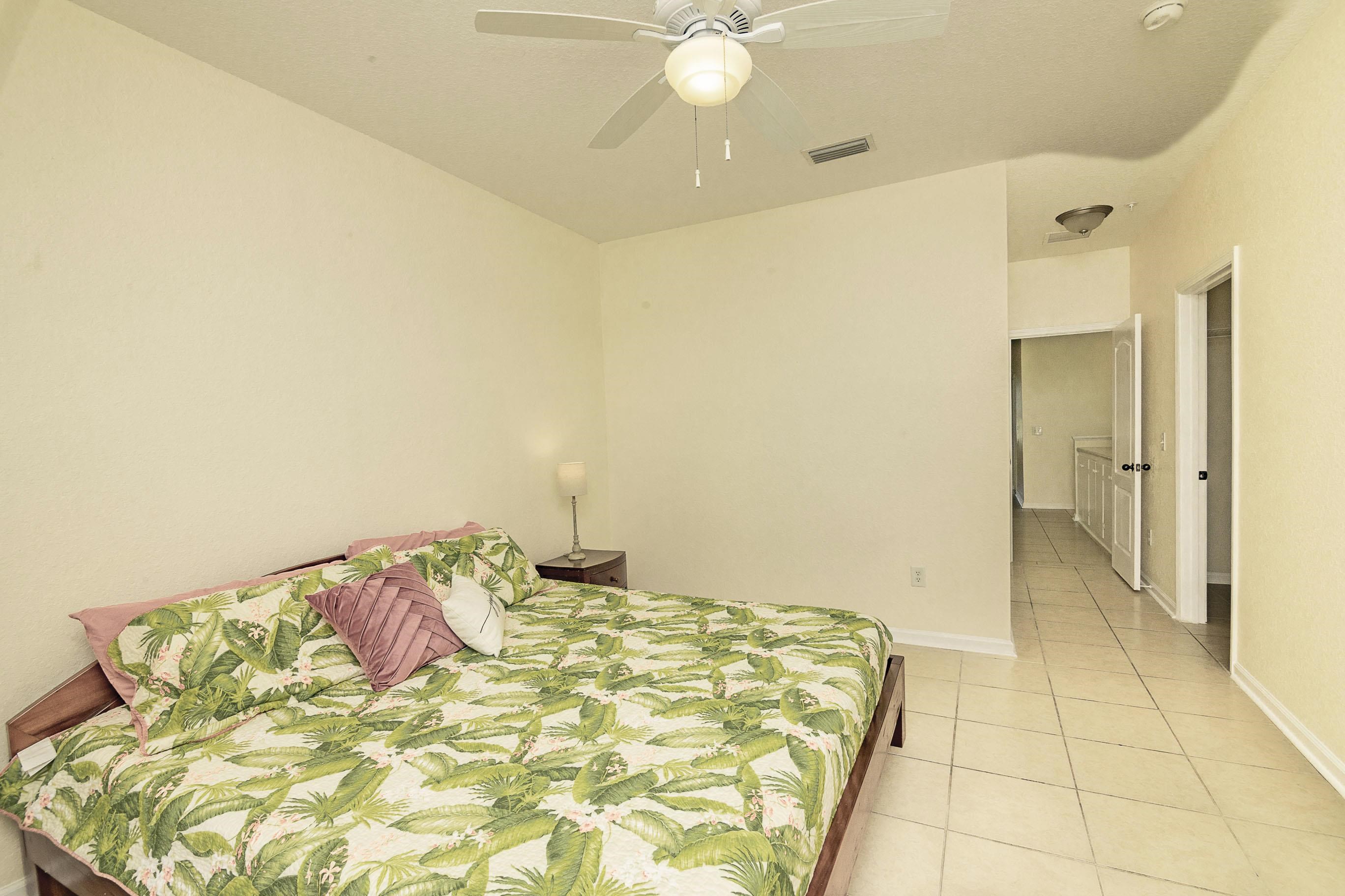 175 Bayberry Circle, Unit 1008 St. Augustine, FL 32086 - Photo 28 of 44 a bedroom with a bed and a chandelier