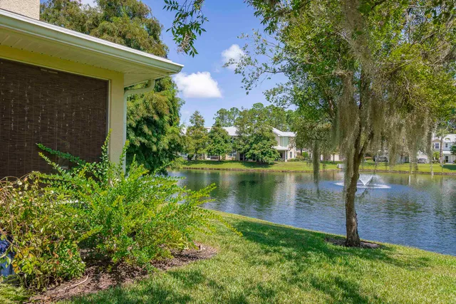 a view of a lake with a house in the background