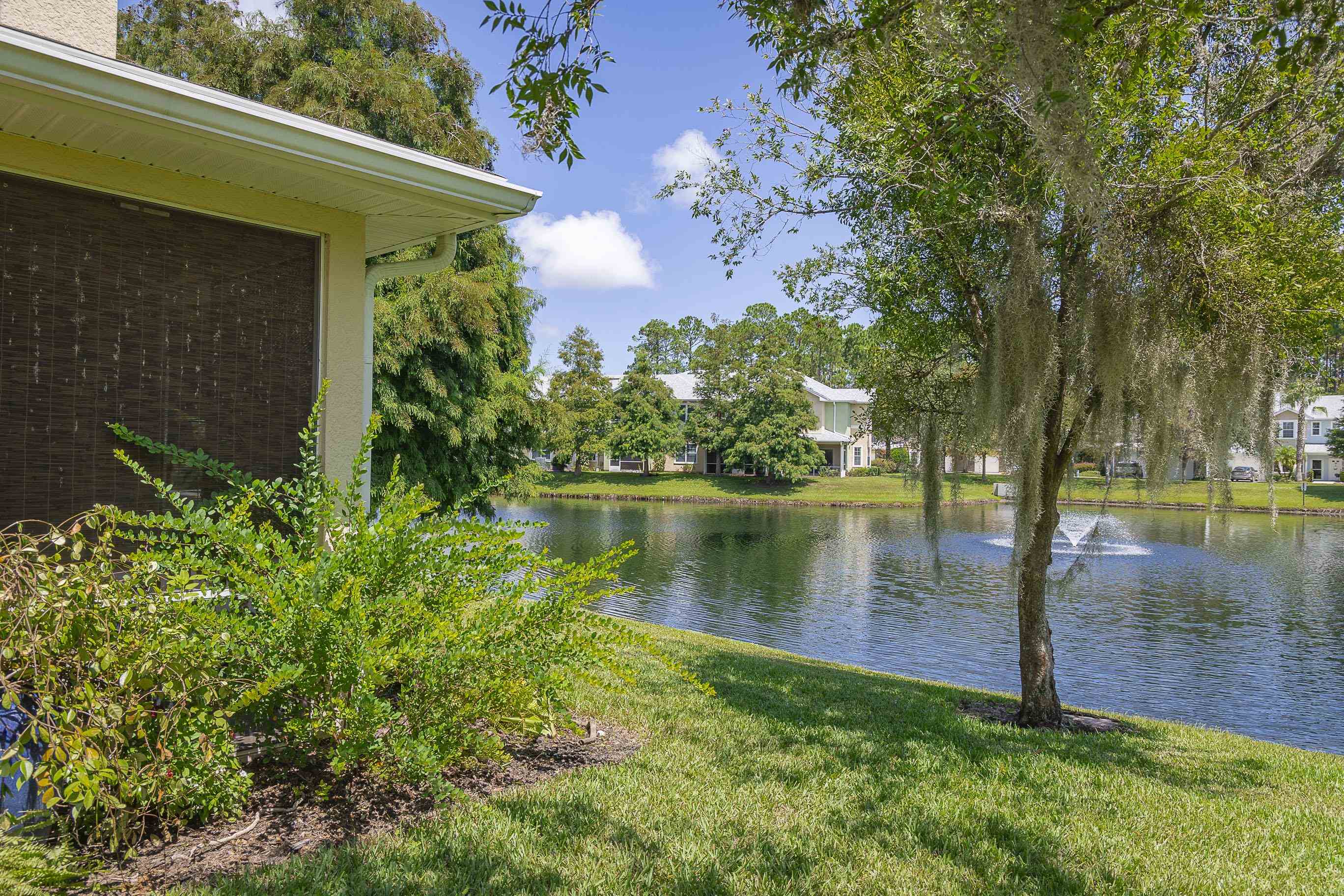 175 Bayberry Circle, Unit 1008 St. Augustine, FL 32086 - Photo 3 of 44 a view of a lake with a house in the background