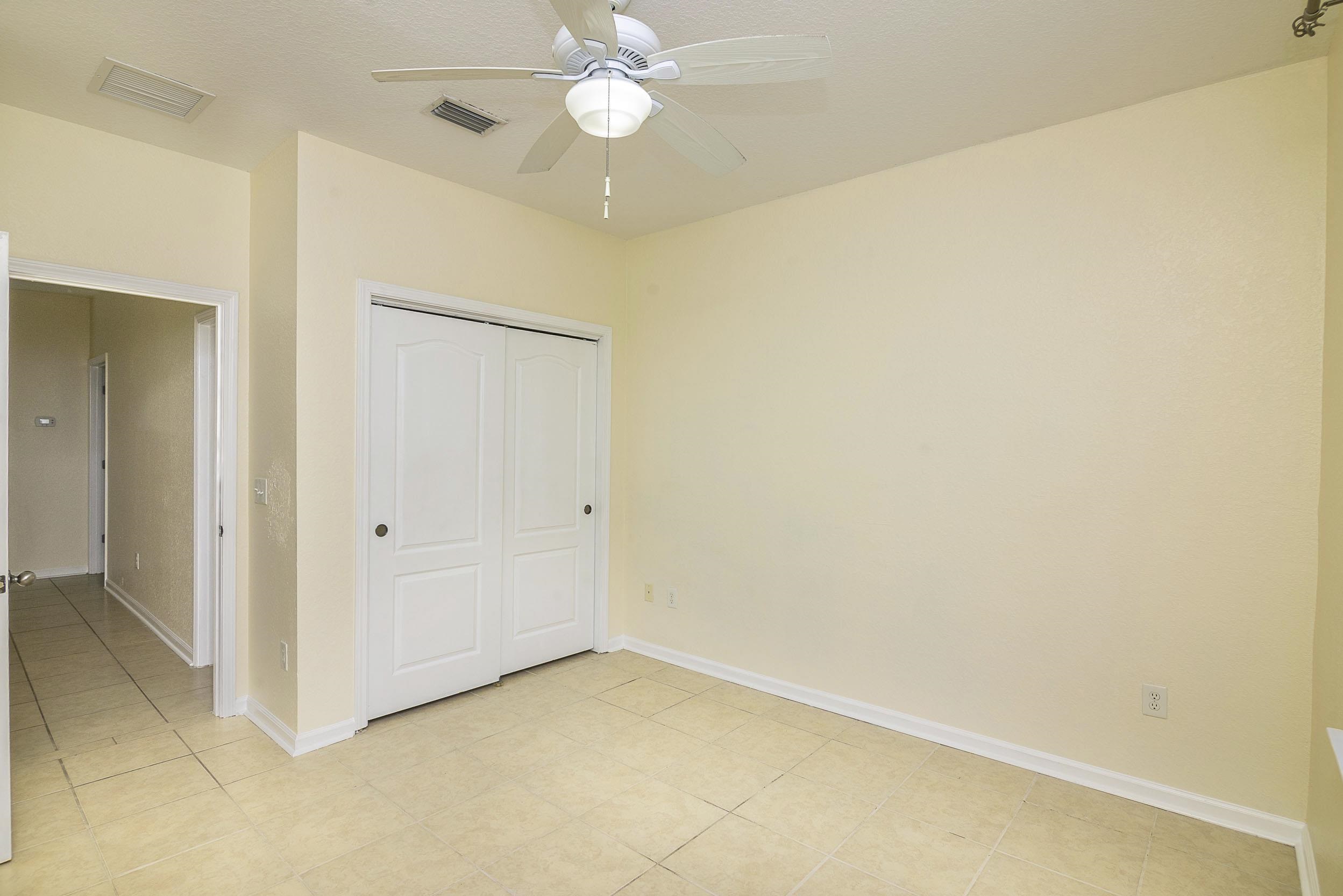 175 Bayberry Circle, Unit 1008 St. Augustine, FL 32086 - Photo 38 of 44 an empty room with a chandelier fan and a shower