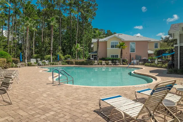 a swimming pool with outdoor seating and yard