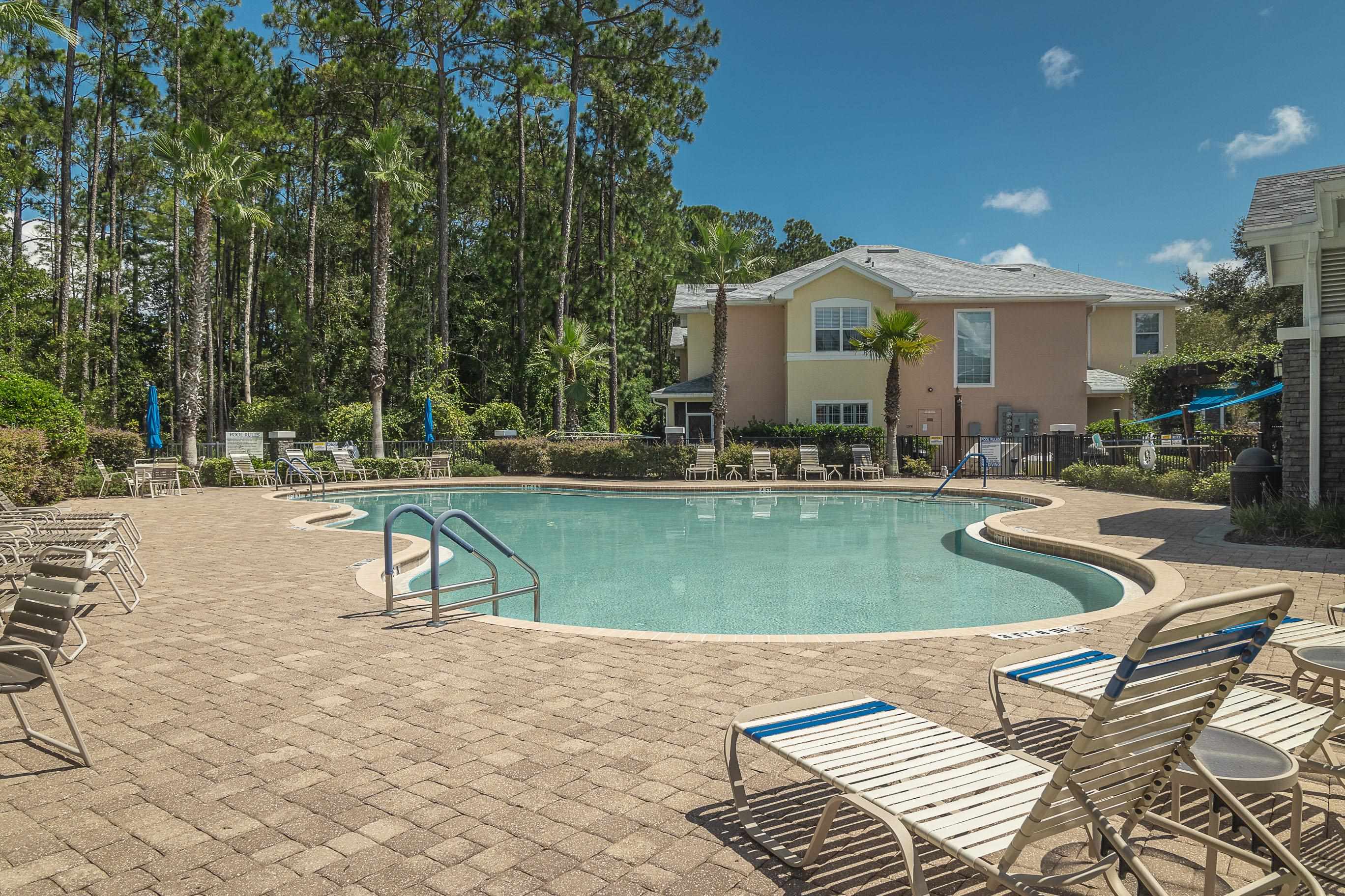 175 Bayberry Circle, Unit 1008 St. Augustine, FL 32086 - Photo 43 of 44 a swimming pool with outdoor seating and yard