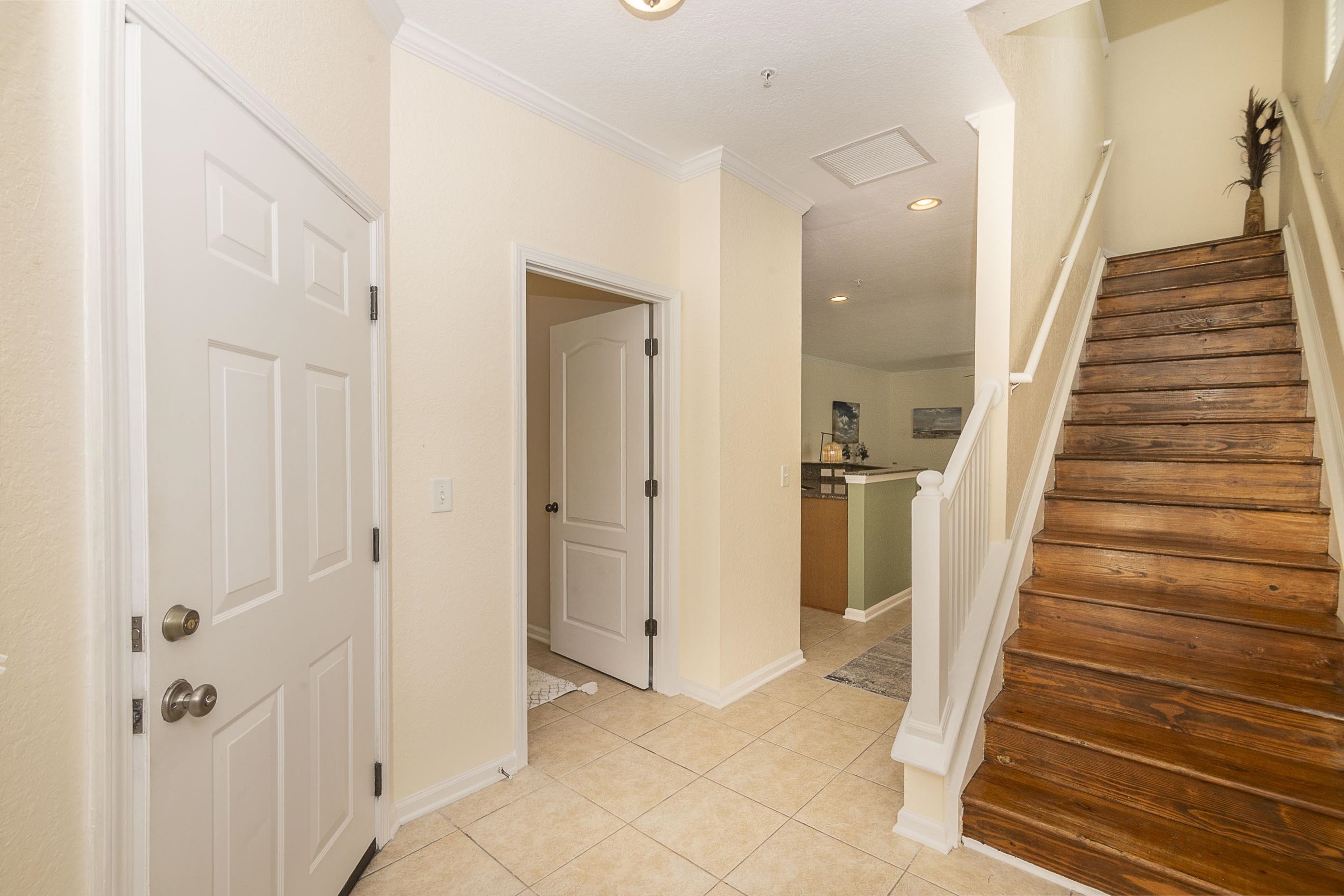 175 Bayberry Circle, Unit 1008 St. Augustine, FL 32086 - Photo 7 of 44 a view of a hallway with wooden floor and staircase