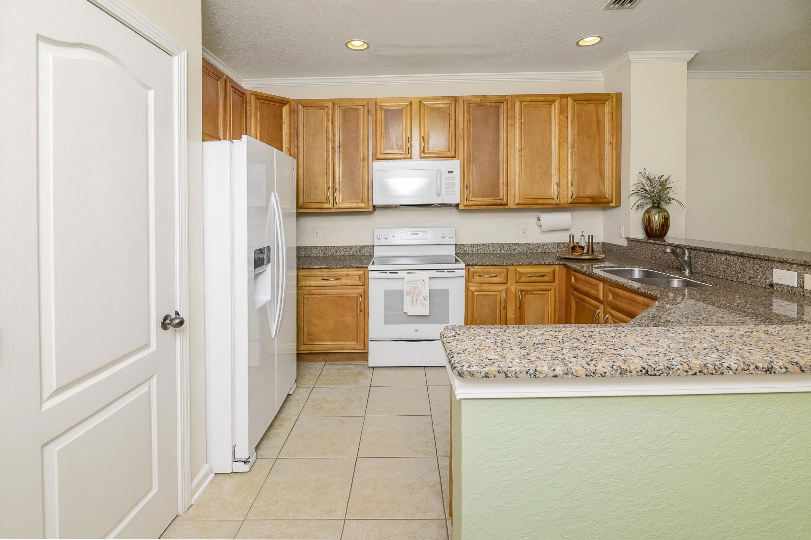 175 Bayberry Circle, Unit 1008 St. Augustine, FL 32086 - Photo 10 of 44 a kitchen with stainless steel appliances granite countertop a refrigerator a sink and a stove