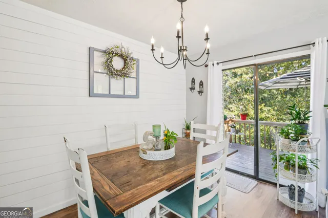 a view of a dining room with a table and chairs