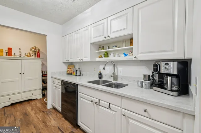 a kitchen with granite countertop cabinets and steel stainless steel appliances