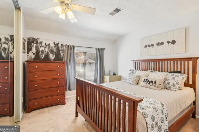 a bedroom with a bed next to a window