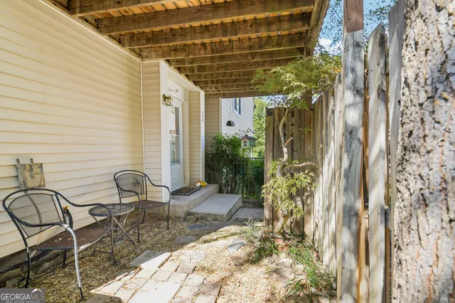 a backyard of a house with table and chairs