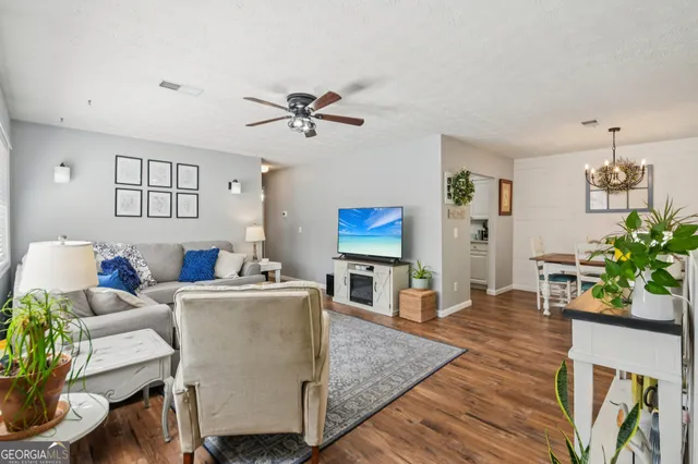 a living room with furniture potted plant and window
