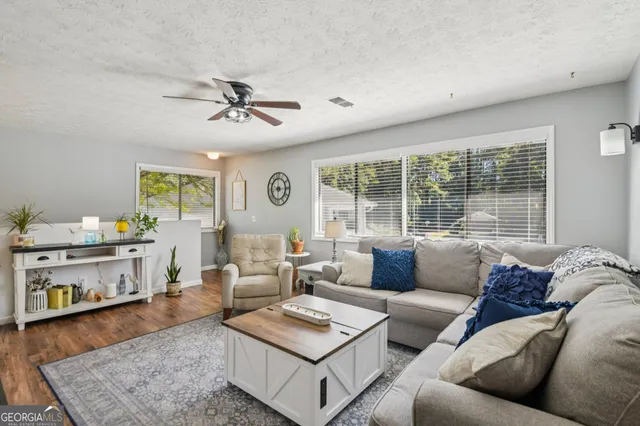 a living room with furniture and wooden floor