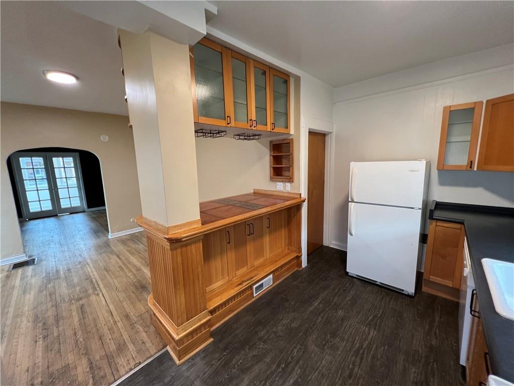300 Grove Street McKees Rocks, PA 15136 - Photo 14 of 25 a kitchen with stainless steel appliances granite countertop a refrigerator a stove a microwave and a refrigerator