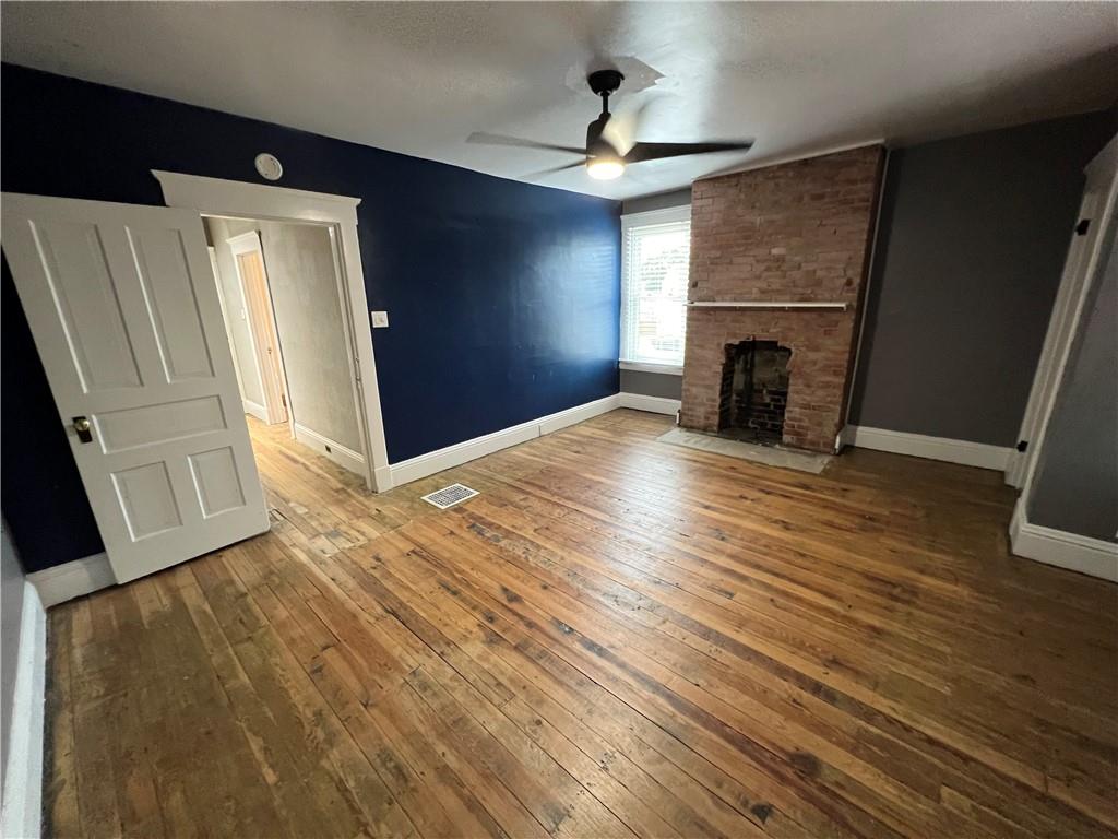 300 Grove Street McKees Rocks, PA 15136 - Photo 19 of 25 a view of empty room with wooden floor and fireplace