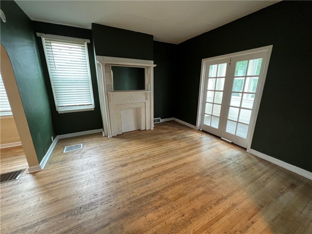 300 Grove Street McKees Rocks, PA 15136 - Photo 6 of 25 a view of empty room with window and wooden floor