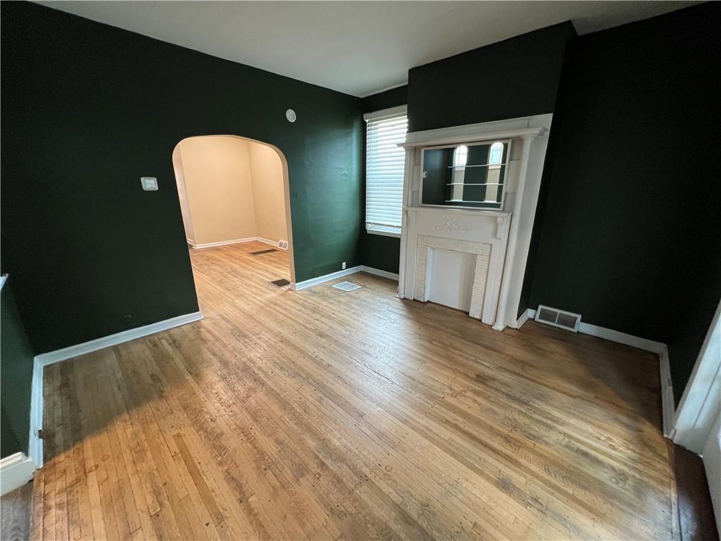 300 Grove Street McKees Rocks, PA 15136 - Photo 7 of 25 a view of a livingroom with wooden floor and kitchen space