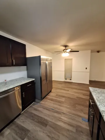 a kitchen with granite countertop a stove and a refrigerator