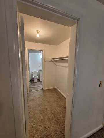 a view of a hallway with a room