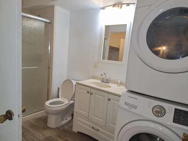 a bathroom with a toilet sink and mirror