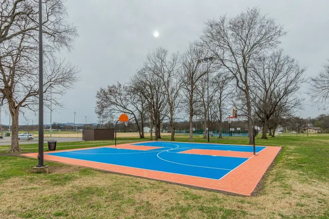 a view of pool with yard and trees