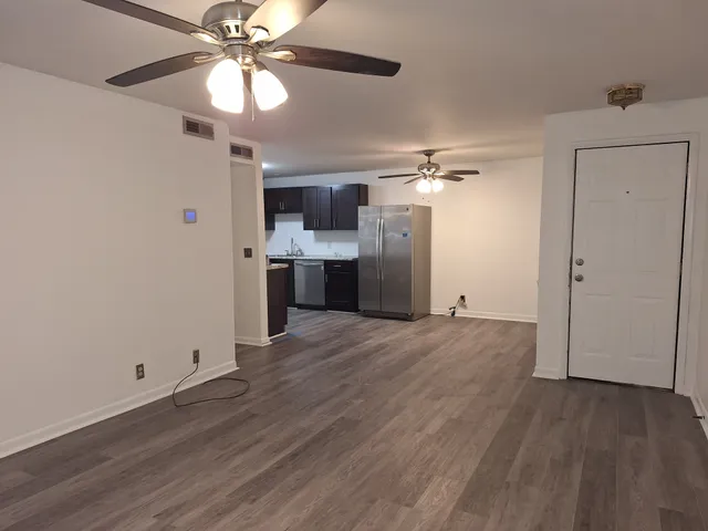 a view of a kitchen with a sink and a refrigerator