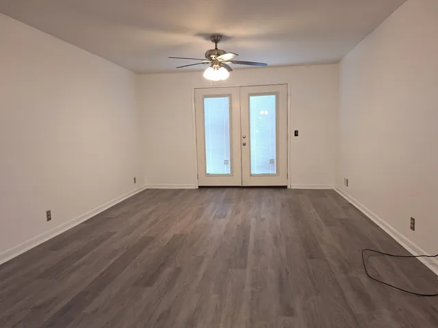 wooden floor in an empty room with a window