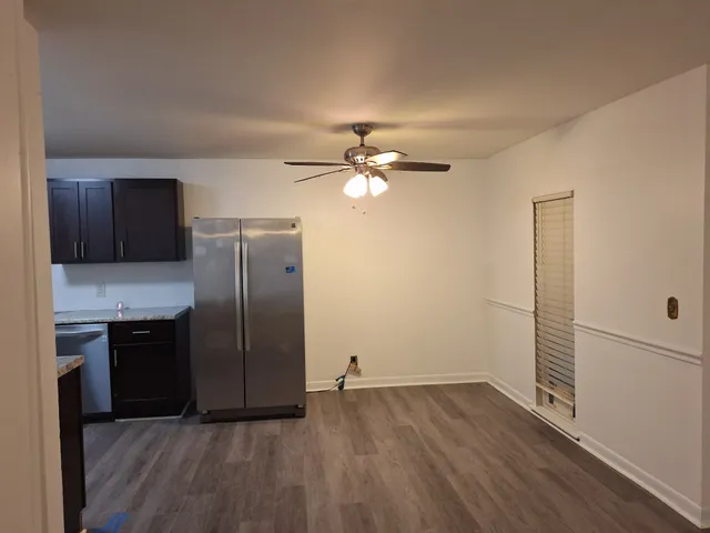 a kitchen with a refrigerator and a stove top oven