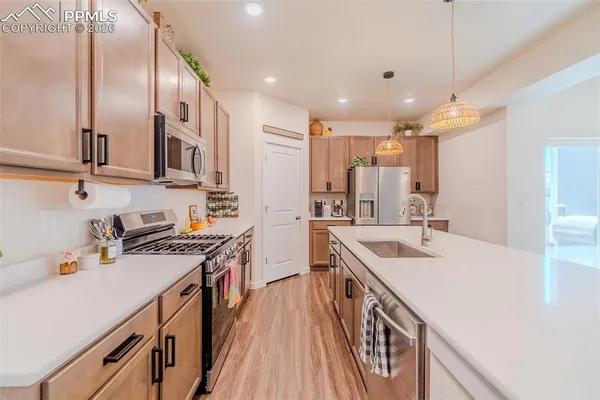 a kitchen with a sink stove and cabinets