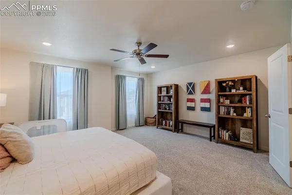 a bedroom with a bed and a book shelf