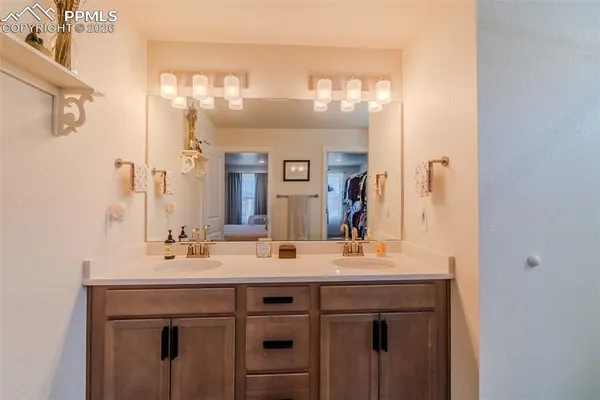 a bathroom with a double vanity sink and a mirror