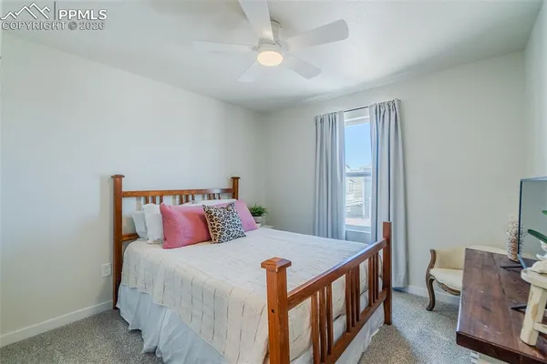a bedroom with bed and wooden floor