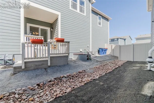 a backyard of a house with barbeque oven table and chairs