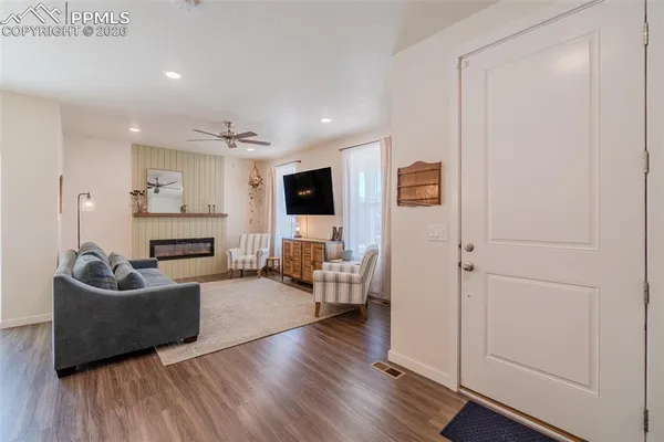 a living room with furniture and a flat screen tv