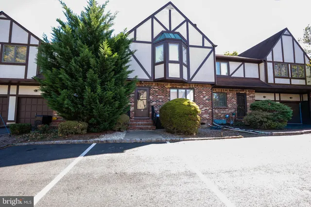 a view of a house with a yard and plants