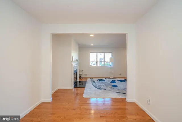 a view of a room with wooden floor and a potted plant