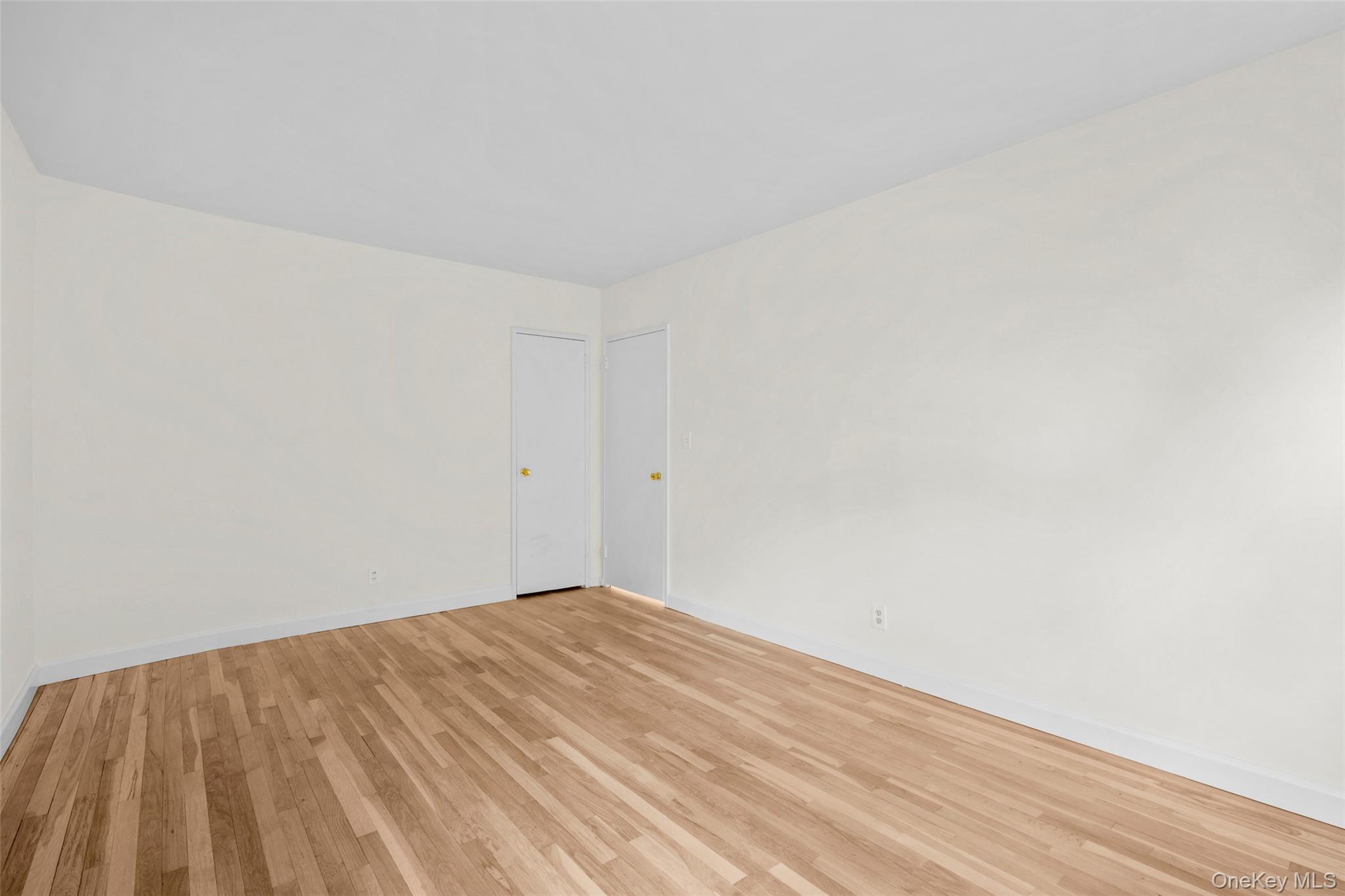 325 Palmer Terrace, Unit 2C Mamaroneck, NY 10543 - Photo 12 of 18 a view of empty room with wooden floor