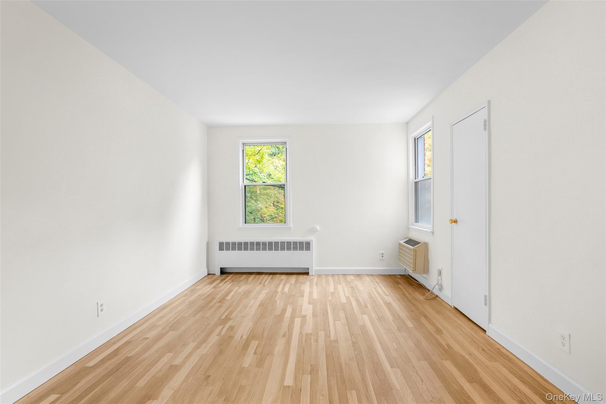 325 Palmer Terrace, Unit 2C Mamaroneck, NY 10543 - Photo 14 of 18 a view of empty room with wooden floor and fan