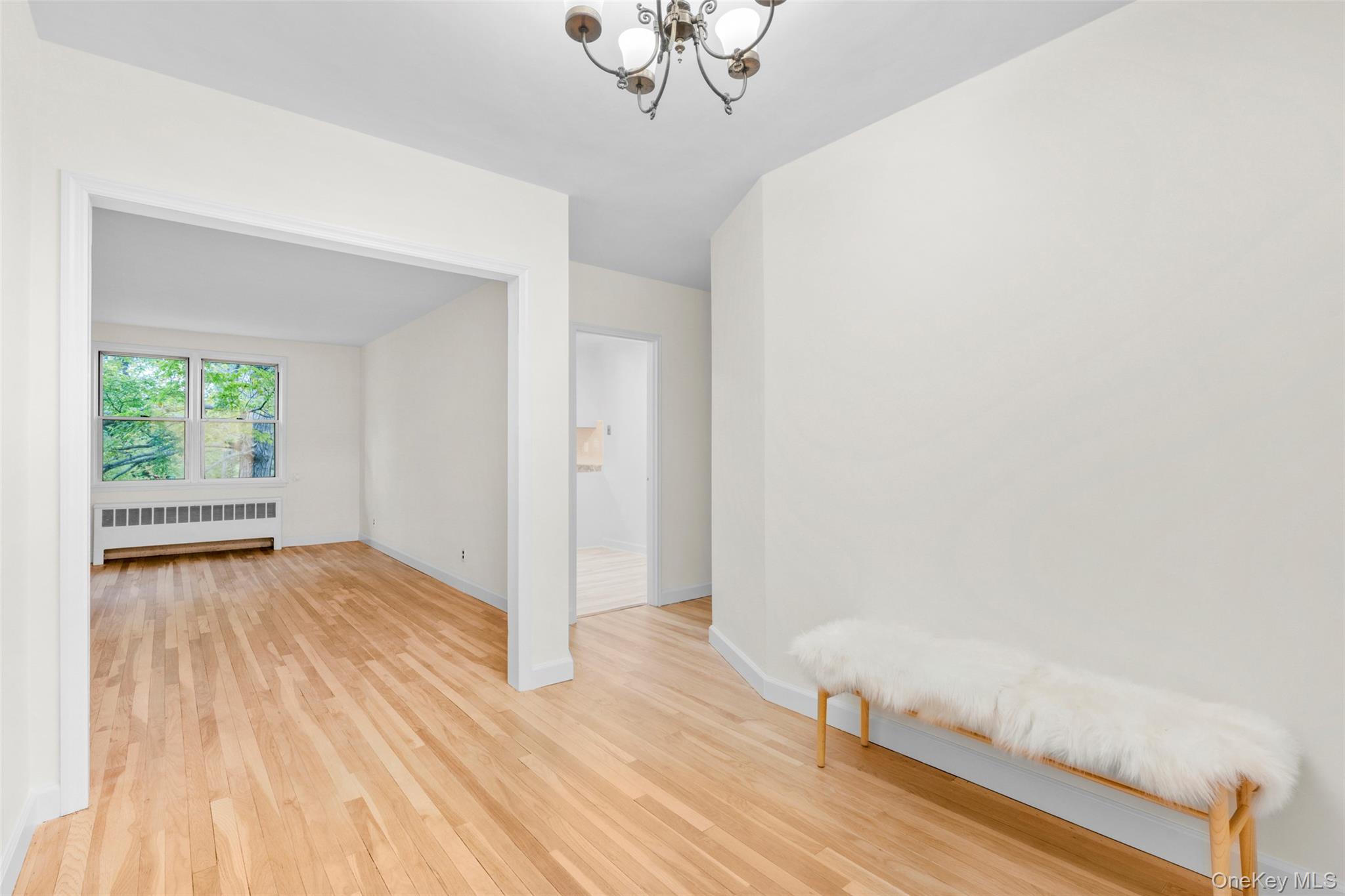 325 Palmer Terrace, Unit 2C Mamaroneck, NY 10543 - Photo 5 of 18 a view of a room with wooden floor and a window