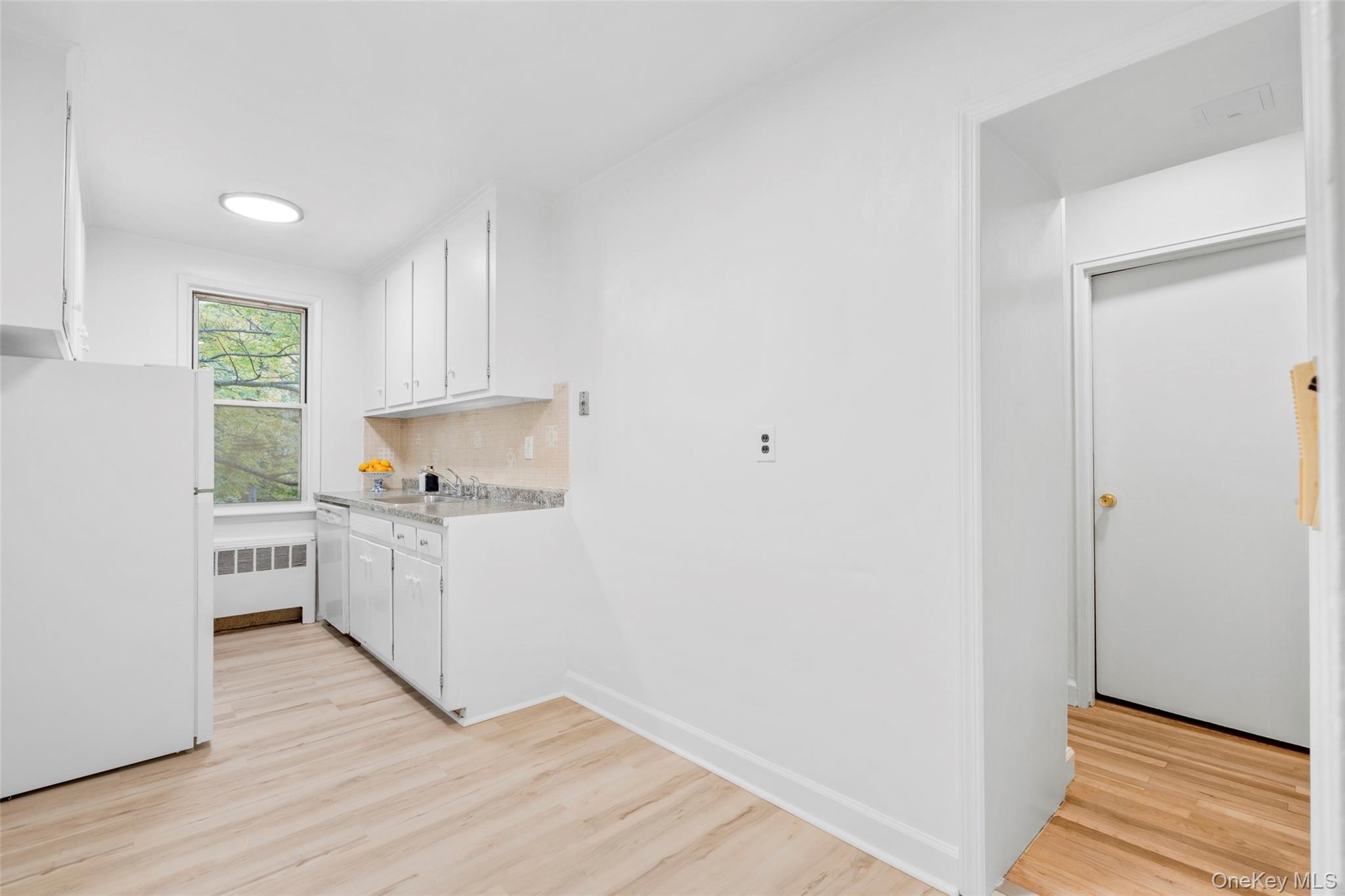 325 Palmer Terrace, Unit 2C Mamaroneck, NY 10543 - Photo 8 of 18 a kitchen with a sink cabinets stainless steel appliances and a window