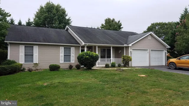a view of a house with a yard and sitting area