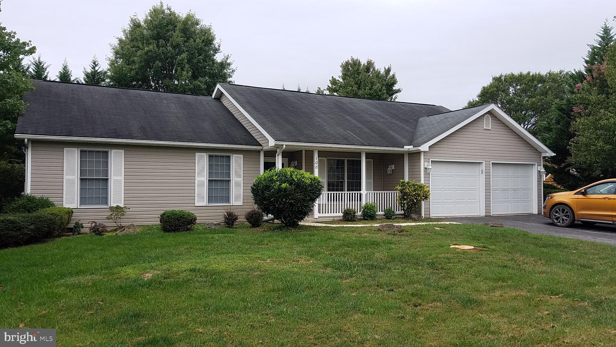 a view of a house with a yard and sitting area