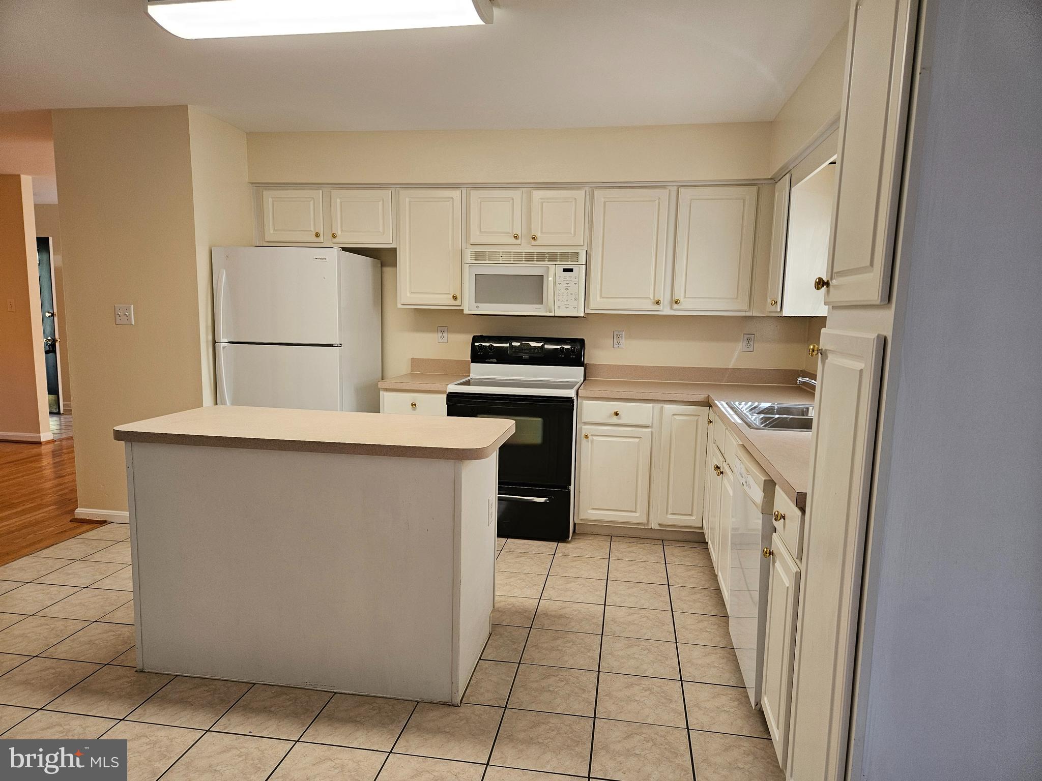 108 Finch Lane Falling Waters, WV 25419 - Photo 11 of 33 a kitchen with cabinets and white appliances