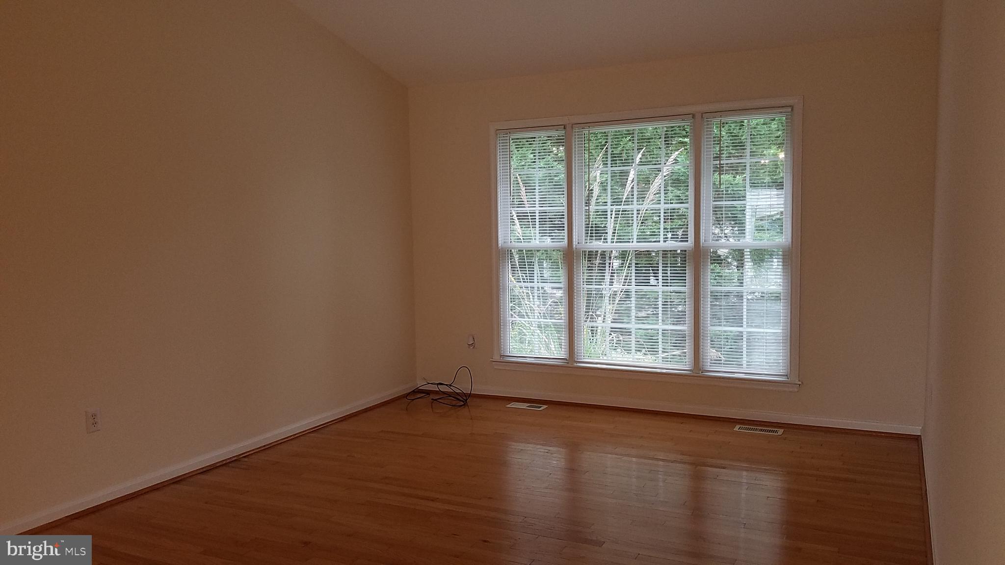 108 Finch Lane Falling Waters, WV 25419 - Photo 14 of 33 a view of an empty room with wooden floor and a window