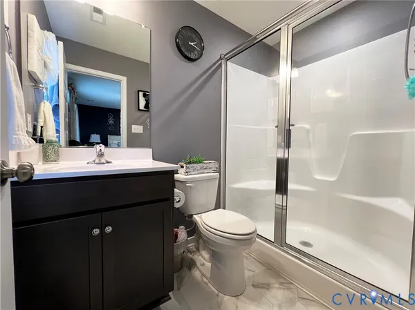 a bathroom with a sink vanity mirror and toilet