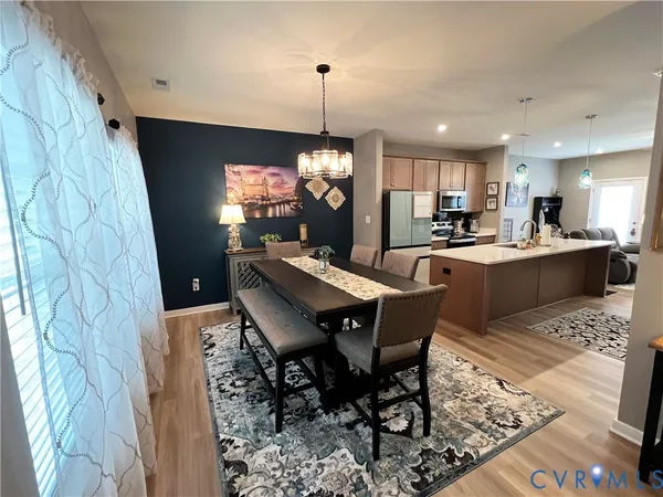 a view of a dining room with furniture and window