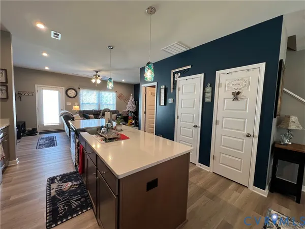 a kitchen with stainless steel appliances kitchen island granite countertop a refrigerator stove top oven and sink