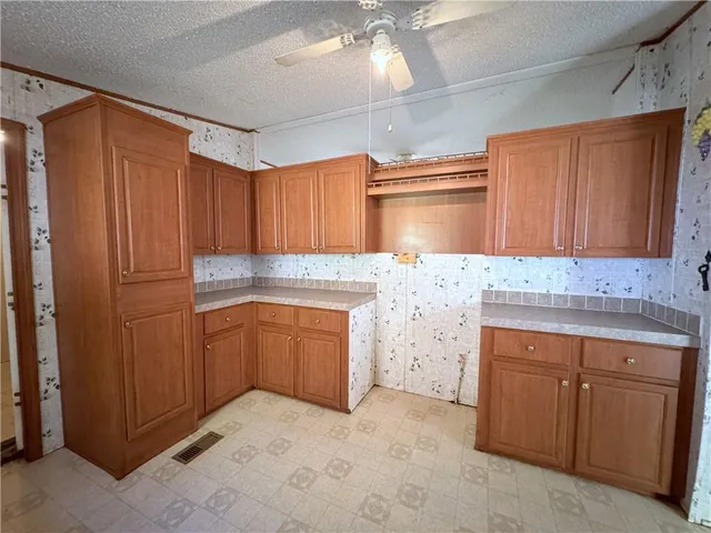 a kitchen with granite countertop cabinets and sink