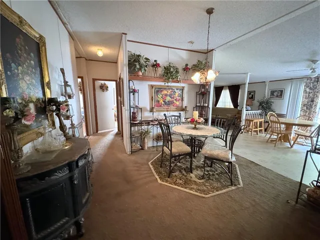 a dining room with furniture and a chandelier