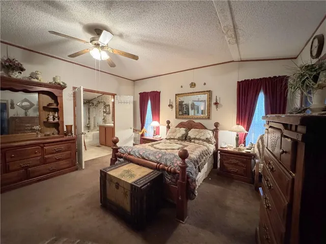 a bedroom with bed and a chandelier