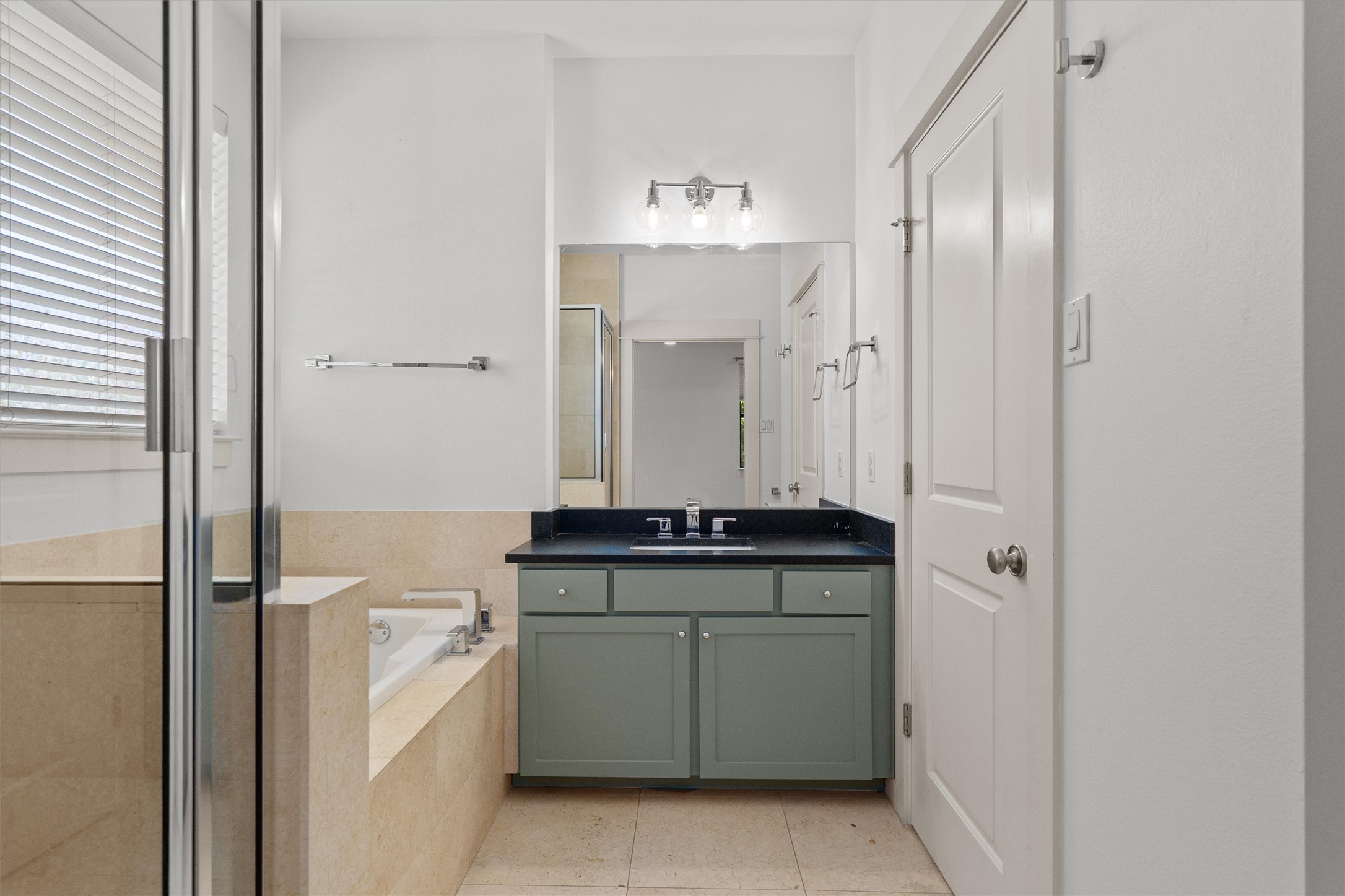 4120 Valley View Road, Unit A Austin, TX 78704 - Photo 17 of 29 a bathroom with a granite countertop sink a toilet and mirror