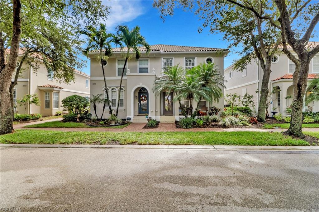 3570 Zanzibar Way Naples, FL 34119 - Photo 1 of 43 a front view of a house with a yard and a garage