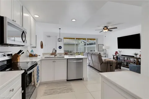 a kitchen with sink a stove and cabinets